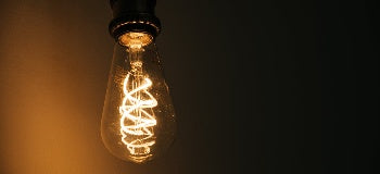 Close up image of light up Edison style light bulb.
