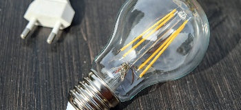 Close up image of single light bulb with power supply.